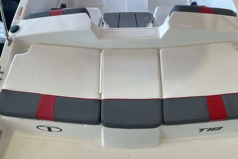 Slide: The Image of 2027 Tahoe T18 boat interior with cushioned seating, featuring red and gray accents. - 7