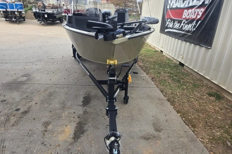 Slide: The Image of 2027 Tracker Pro Guide V-16 SC boat on trailer, parked outdoors near dealership. - 22