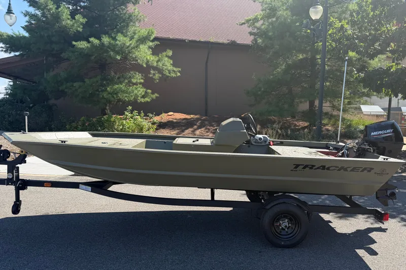 The Image of 2027 Tracker Grizzly 1648 SC boat on trailer, parked outdoors. - 0