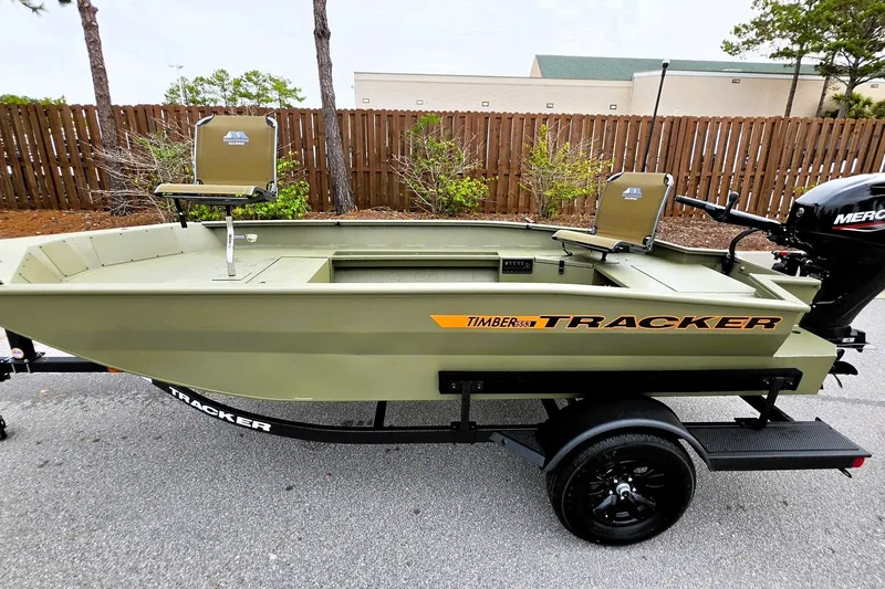 Slide: The Image of 2027 Tracker Grizzly 1553 Timber boat on trailer, parked outdoors. - 13