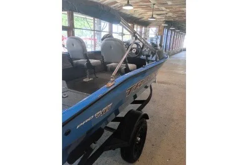 The Image of 2027 Tracker Pro Guide V-16 SC boat in a showroom, showcasing interior seating and design. - 0