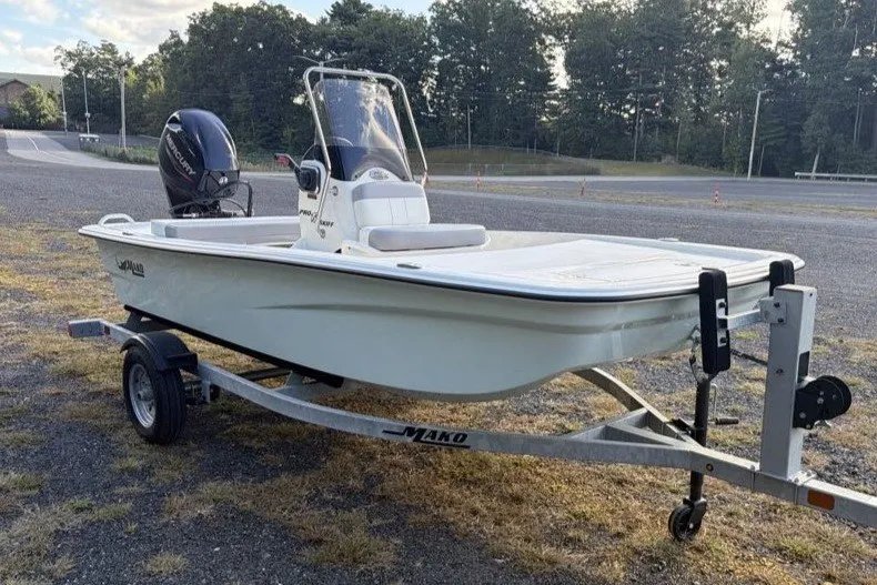 The Image of 2026 Mako Pro Skiff 13 CC boat on trailer, parked outdoors. - 0