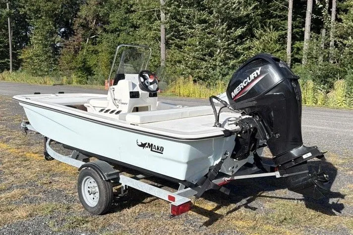 Slide: The Image of 2026 Mako Pro Skiff 13 CC boat on trailer with Mercury outboard motor. - 5