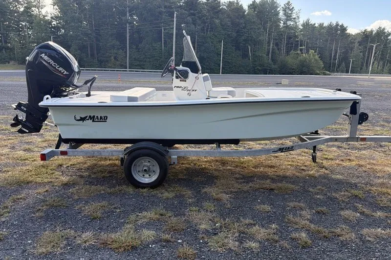 Slide: The Image of 2026 Mako Pro Skiff 13 CC boat on trailer, featuring a Mercury outboard motor. - 3