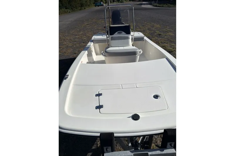 Slide: The Image of 2026 Mako Pro Skiff 13 CC boat with center console, parked on a trailer. - 7