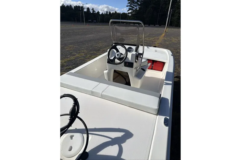 Slide: The Image of 2026 Mako Pro Skiff 13 CC boat interior with steering console and seating. - 6