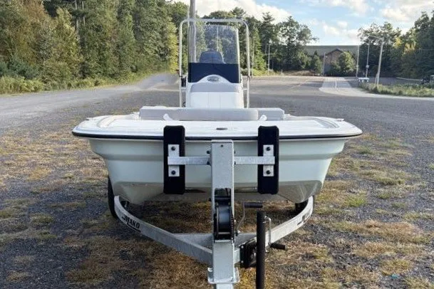 Slide: The Image of 2026 Mako Pro Skiff 13 CC on trailer, parked outdoors on gravel road. - 4
