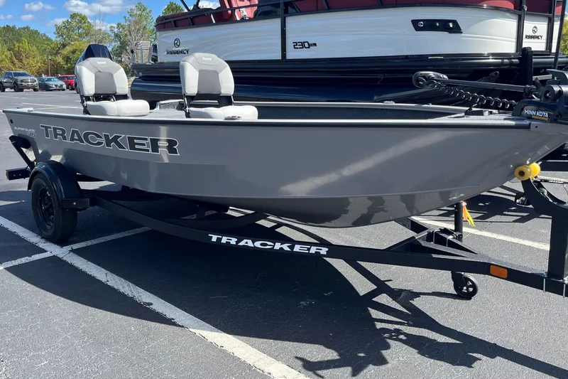 The Image of 2027 Tracker Super Guide V-16 T fishing boat on trailer in parking lot. - 0