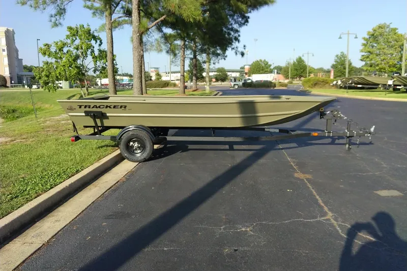 The Image of 2027 Tracker Grizzly 1754 Utility boat on trailer in parking lot. - 0