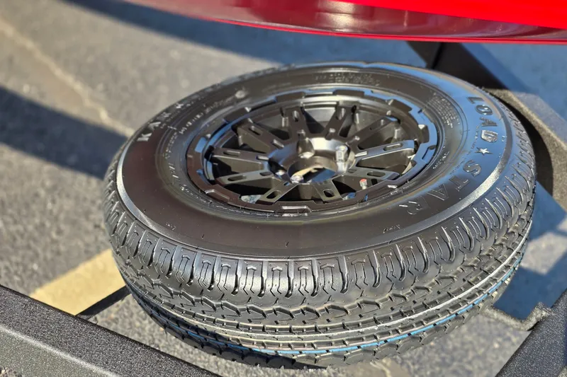 Slide: The Image of Spare tire on a 2027 Tracker Savage 215 trailer, featuring a Load Star tire. - 22