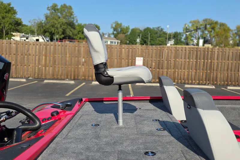 Slide: The Image of 2027 Tracker Savage 215 boat with elevated seating, parked outdoors. - 15