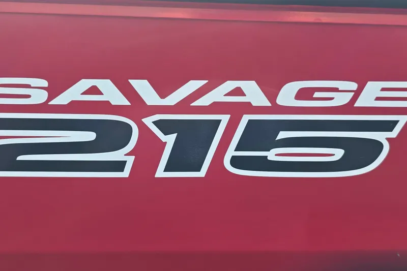 Slide: The Image of Red Tracker Savage 215 logo, 2027 model, bold white and black text. - 18
