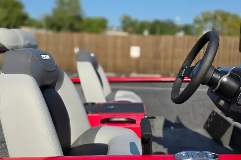 Slide: The Image of 2027 Tracker Savage 215 boat interior with steering wheel and seats. - 14