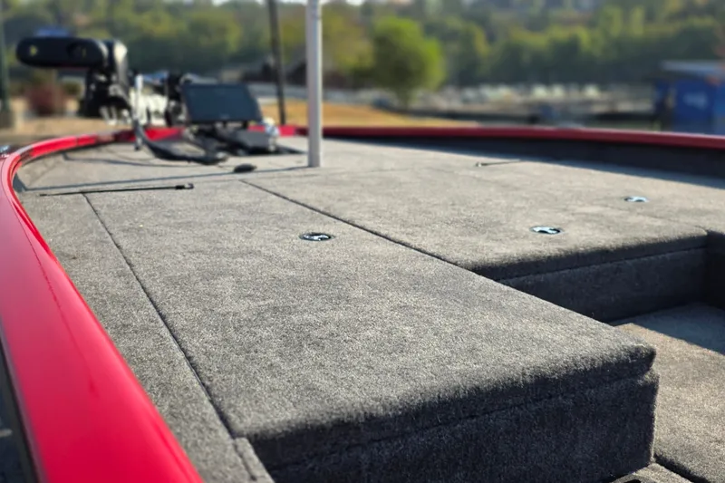 Slide: The Image of 2027 Tracker Savage 215 boat deck with red trim and fishing equipment. - 20