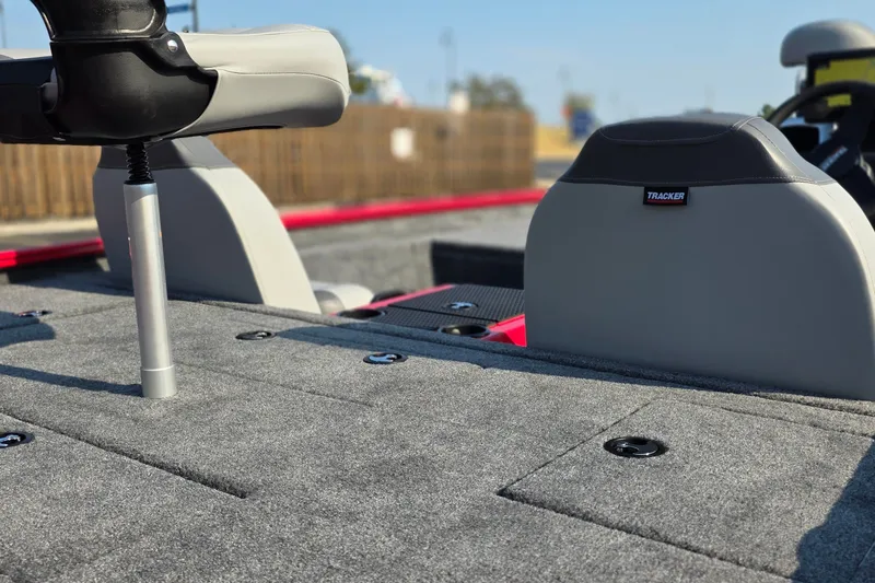 Slide: The Image of 2027 Tracker Savage 215 boat interior with gray seating and carpeted deck. - 16