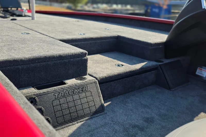 Slide: The Image of Interior view of 2027 Tracker Savage 215 boat, featuring carpeted deck and storage compartments. - 23