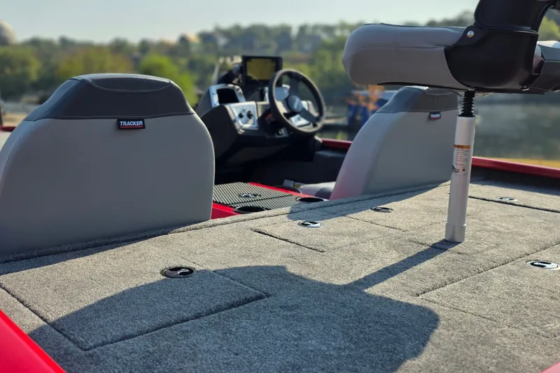 Slide: The Image of 2027 Tracker Savage 215 boat interior with seats and steering wheel, showcasing modern design. - 17