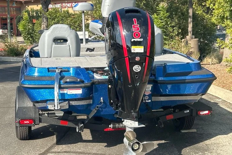 Slide: The Image of 2027 Nitro Z18 XL Pro boat with powerful 150 HP engine, parked outdoors. - 1