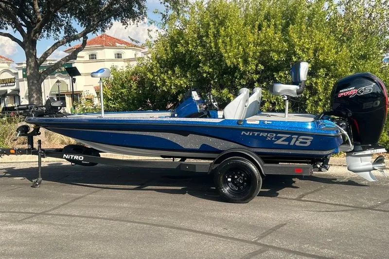 Slide: The Image of 2027 Nitro Z18 XL Pro boat with Mercury engine on trailer, parked outdoors. - 6