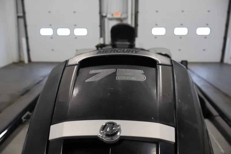 Slide: The Image of 2019 Tracker Pro Team 175 TXW with Mercury 75 engine in a garage setting. - 45