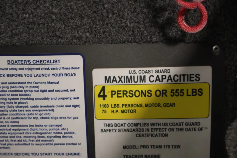 Slide: The Image of 2019 Tracker Pro Team 175 TXW capacity label, 4 persons or 555 lbs, with boater's checklist. - 32