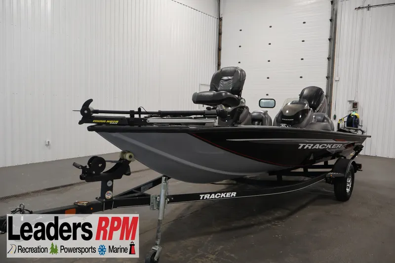 The Image of 2019 Tracker Pro Team 175 TXW fishing boat on trailer in indoor showroom. - 0