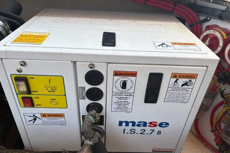 Slide: The Image of Mase I.S.2.7B generator on 2017 Ranger Tugs R-27 boat, with warning labels. - 71