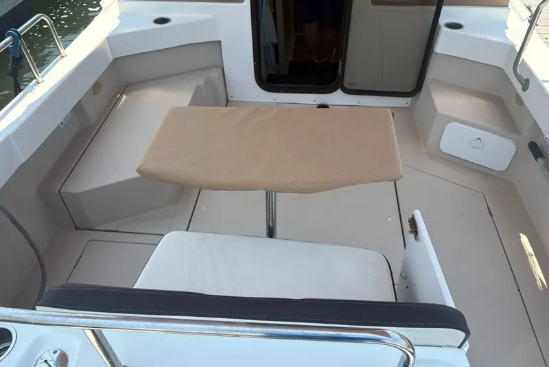 Slide: The Image of 2017 Ranger Tugs R-27 boat interior with seating and table in the cockpit area. - 14