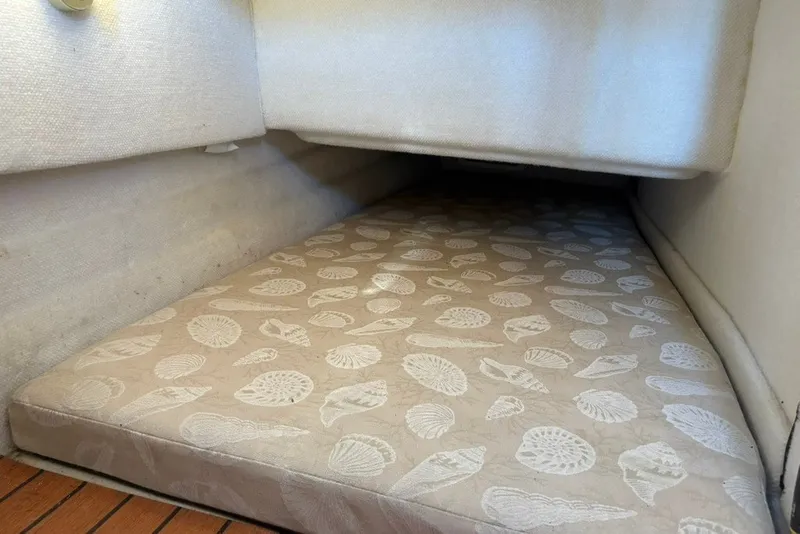Slide: The Image of 2017 Ranger Tugs R-27 cabin interior with patterned mattress and wooden flooring. - 56