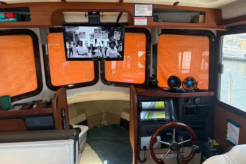 Slide: The Image of Interior of 2017 Ranger Tugs R-27 boat with navigation equipment and TV screen. - 25