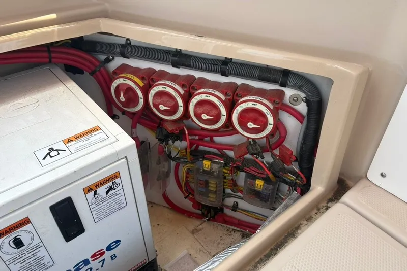 Slide: The Image of Electrical panel of a 2017 Ranger Tugs R-27 boat with wiring and switches. - 70