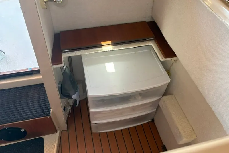 Slide: The Image of Interior storage area of a 2017 Ranger Tugs R-27 boat with plastic drawers. - 57