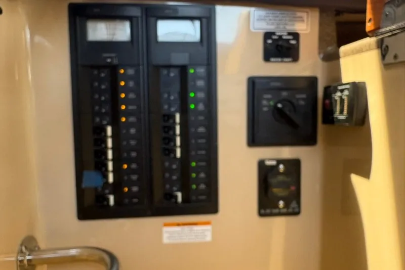 Slide: The Image of Control panel of a 2017 Ranger Tugs R-27 boat with switches and indicators. - 30
