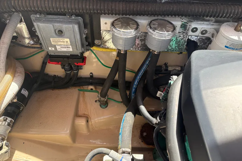Slide: The Image of Engine compartment of a 2017 Ranger Tugs R-27, featuring hoses and components. - 63