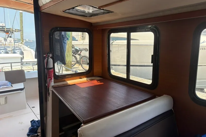 Slide: The Image of Interior of 2017 Ranger Tugs R-27 boat with table and windows. - 41