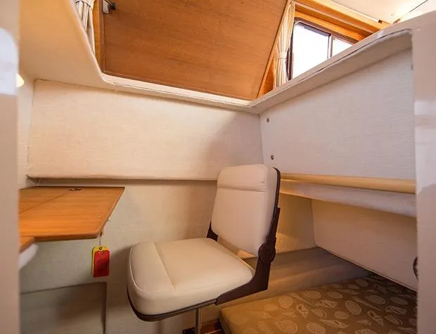 Slide: The Image of Manufacturer Provided Image: Interior cabin of 2017 Ranger Tugs R-27 with seating and wooden table. - 58