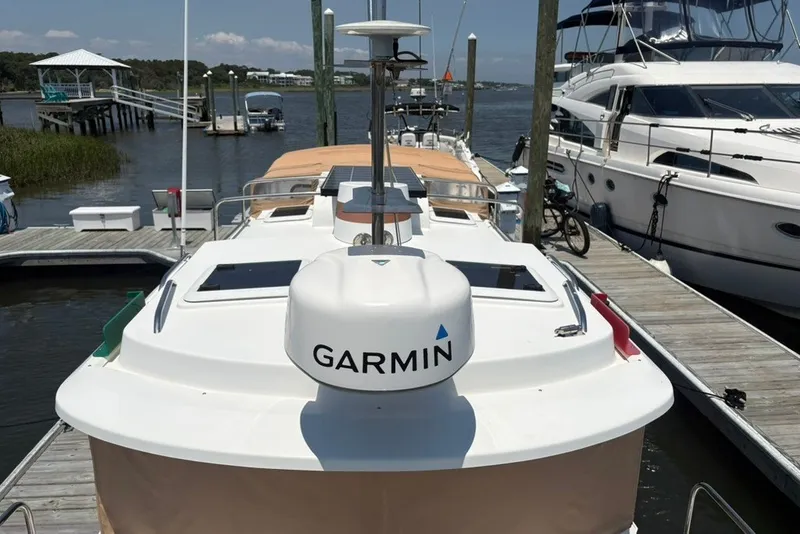 Slide: The Image of 2017 Ranger Tugs R-27 docked with Garmin navigation system, surrounded by water and boats. - 21