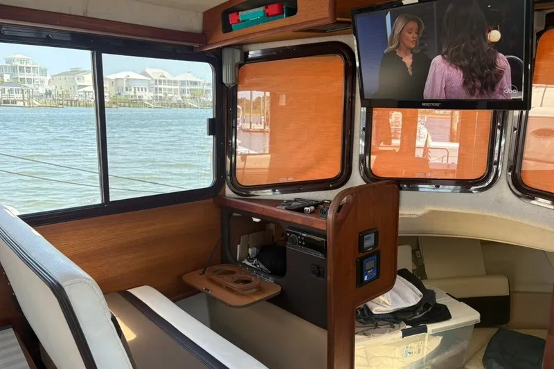 Slide: The Image of Interior of 2017 Ranger Tugs R-27 boat with TV and waterfront view. - 36