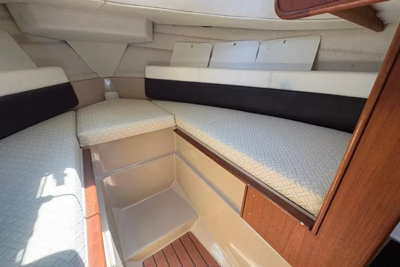 Slide: The Image of 2017 Ranger Tugs R-27 cabin interior with cushioned seating and wooden accents. - 43