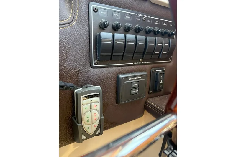 Slide: The Image of Control panel of 2017 Ranger Tugs R-27 boat with switches and remote. - 31