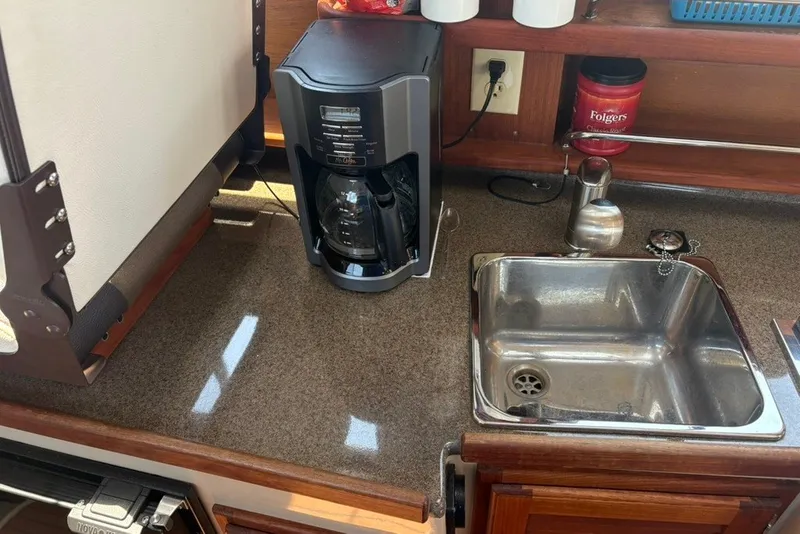 Slide: The Image of 2017 Ranger Tugs R-27 galley with coffee maker and stainless steel sink. - 51