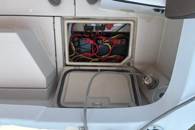 Slide: The Image of 2017 Ranger Tugs R-27 boat battery compartment with wiring and connections. - 65