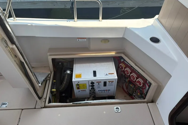 Slide: The Image of 2017 Ranger Tugs R-27 engine compartment with Mase generator and electrical components. - 68