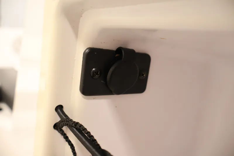 Slide: The Image of 2020 Bayliner VR4 Bowrider I/O interior detail showing a black power outlet. - 28