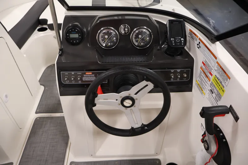 Slide: The Image of 2020 Bayliner VR4 Bowrider I/O dashboard with steering wheel and control panel. - 18