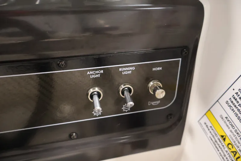 Slide: The Image of Control panel of a 2020 Bayliner VR4 Bowrider I/O with switches for anchor light, running light, and horn. - 24