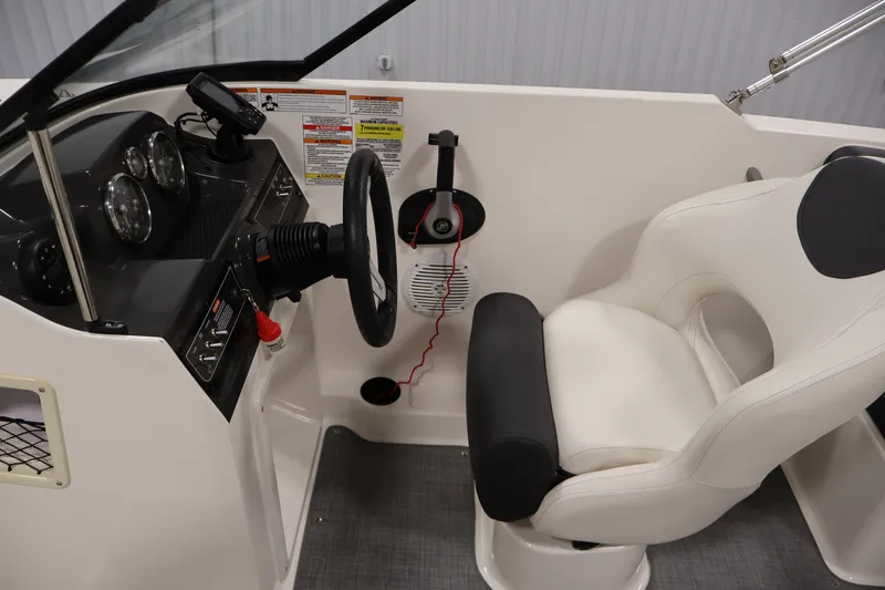 Slide: The Image of 2020 Bayliner VR4 Bowrider I/O cockpit with steering wheel and white captain's chair. - 17