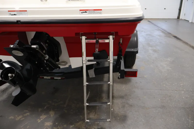 Slide: The Image of 2020 Bayliner VR4 Bowrider I/O rear view with ladder and propeller in a garage. - 43