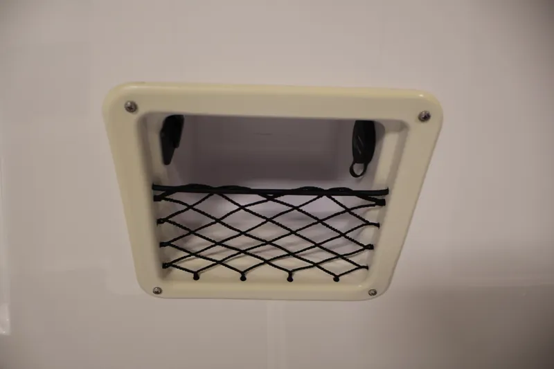 Slide: The Image of Storage compartment with netting on a 2020 Bayliner VR4 Bowrider I/O boat. - 26