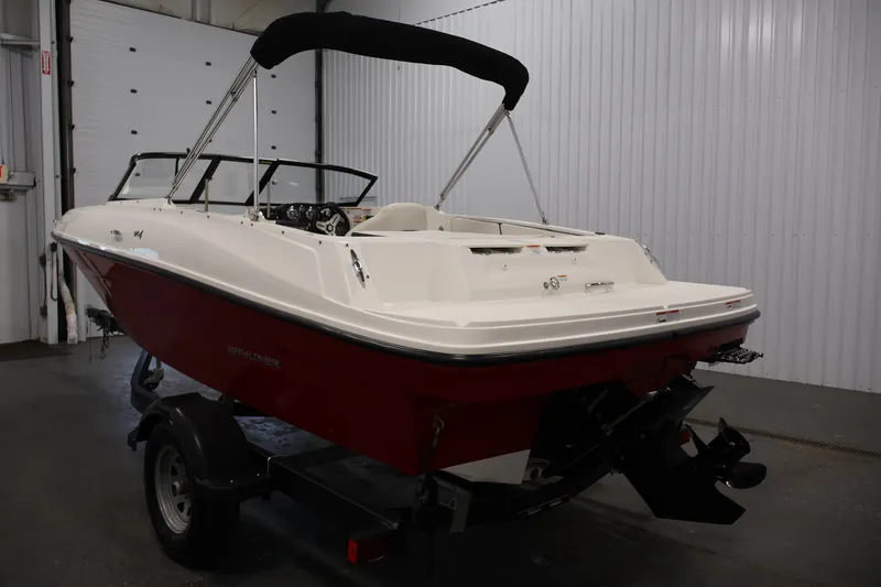 Slide: The Image of 2020 Bayliner VR4 Bowrider I/O in a garage, featuring a red and white exterior. - 7